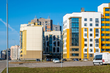 Modern Yellow and White Apartment Buildings in New Residential District Under Clear Blue Sky © Eugeniusz