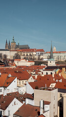 Obraz premium Prague Castle and St Vitus Cathedral over red tile roofs of Malá Strana skyline