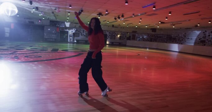 Epic, cinematic shot following professional young female skater across disco floor