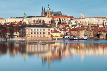Fototapeta premium Prague Castle and St Vitus Cathedral above Vltava River with calm reflective water
