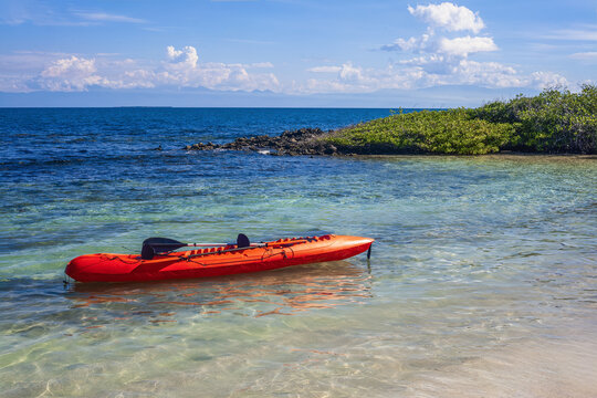 Orange kayak floating on tropical clear water in morrocoy