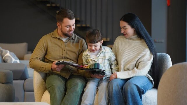 Happy family choosing fabric color samples in furniture store