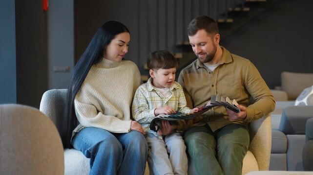 Young family choosing upholstery fabric in furniture store