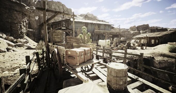 A deserted settlement in a dry landscape features wooden buildings, cargo crates, and a wagon. Dusty roads and rocky terrain contribute to the desolate atmosphere of this old town.