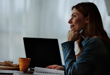 Woman thinking while sitting at a table