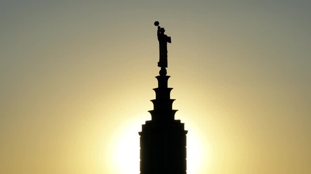 Aerial Silhouette of LDS Temple Spire Against Golden Sunset
