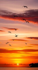 Fototapeta premium Birds flying over sunset landscape sea.