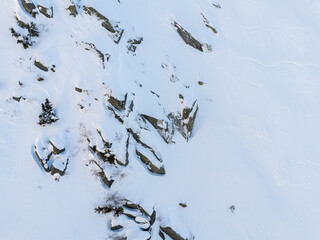 Aerial View of Snow-Covered Rocky Mountains and Evergreen Trees in BC, Canada Winter Landscape