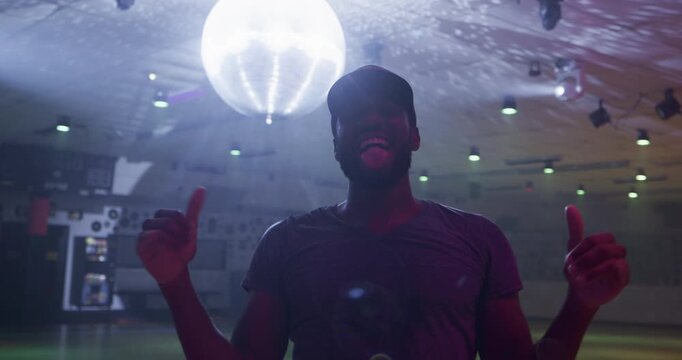 Man in disco room doing fun gestures - steady cam medium shot