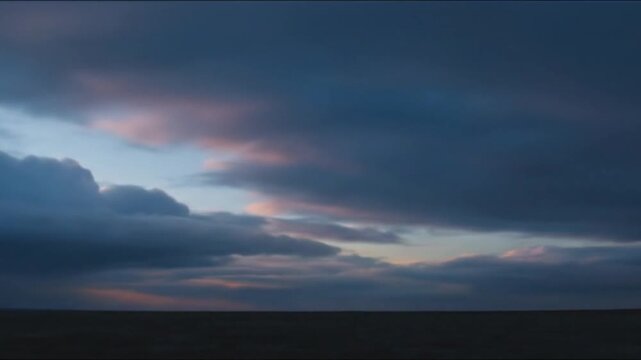 Cold Wind Moving Storm Clouds Across Empty Horizon Creating Dark Cinematic Landscape With Dramatic Weather And Atmospheric Motion