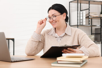 Professional accountant working at wooden desk in office