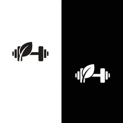 Obraz premium Dumbbell with Leaf Symbolizing Healthy Fitness and Nature.