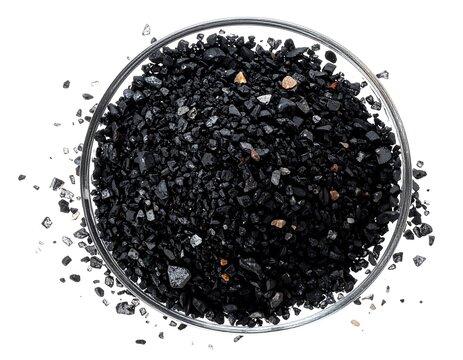 Close-up of Black Anthracite Coal Pieces in a Glass Bowl on White Background