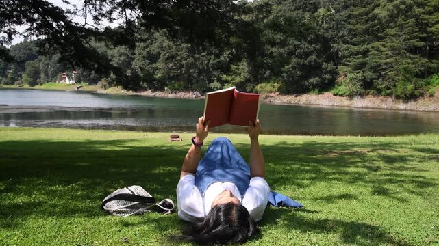 Female Visitor Reading next to the Presa Brockman Lake