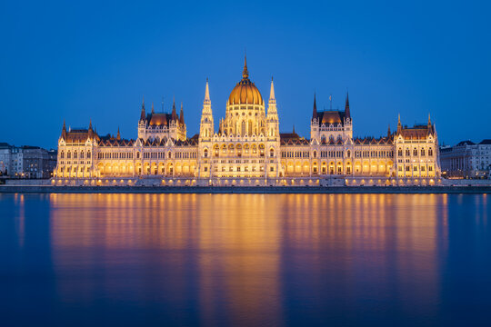 The Budapest Parliament building at nightfall on the Danube river bank