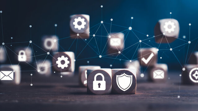Focused security and protection icons on dark wooden blocks amidst a blurred digital network.