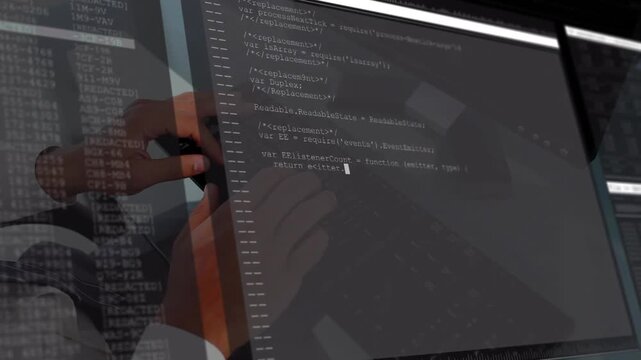 Male developer typing on keyboard at glass desk, causing app code filling monitor reflecting hands