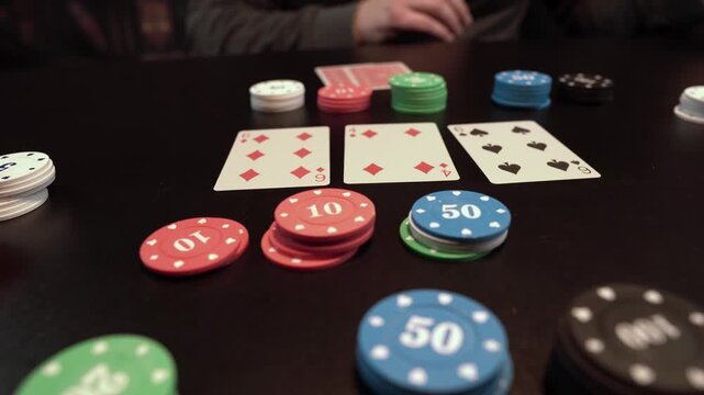 Men Playing Texas Holdem Poker, Cards and Chips on Table, Close Up