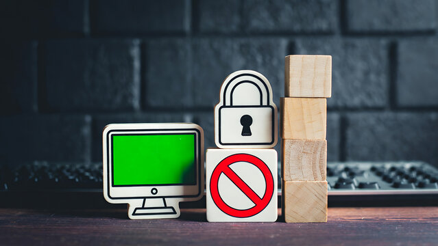 A monitor, padlock, stop sign, and wooden blocks symbolize digital restriction and security.