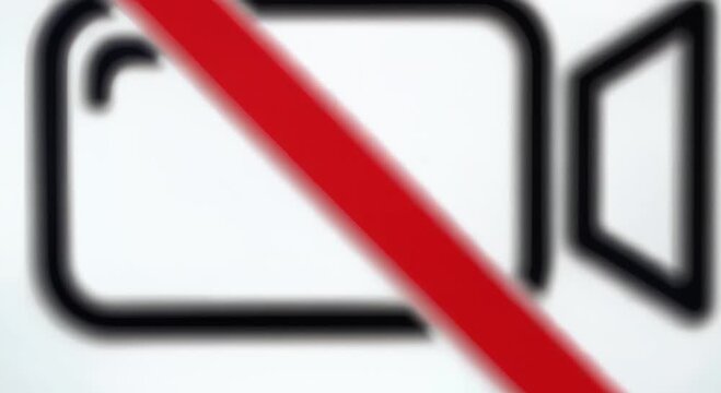 no video sign on gray textured wall with red prohibition circle