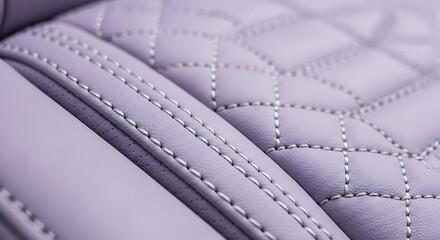 Fototapeta premium Close-up view of quilted leather car seat with detailed stitching.