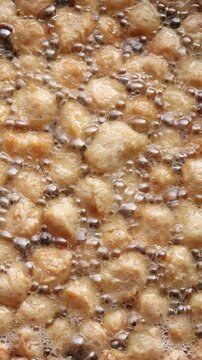 Deep-frying textured vegetable protein chunks or soy meat in hot bubbling oil. Plant-based food