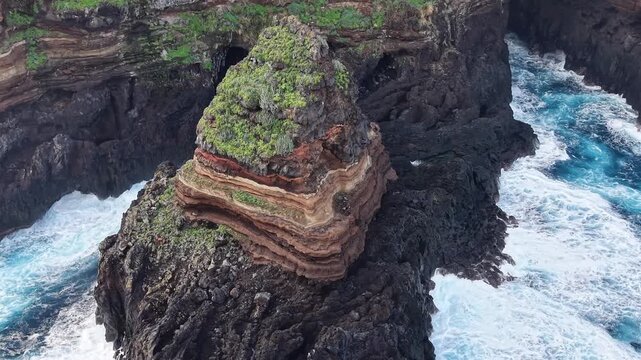 Breathtaking aerial footage of the iconic Roque de El Cagado in Santa Ursula, a unique geological formation on the coast of Tenerife, Spain