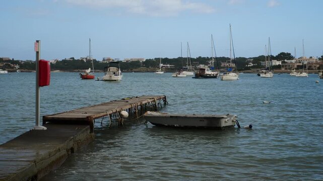 A small boat moored to a pontoon in Portocolom, Mallorca, Spain