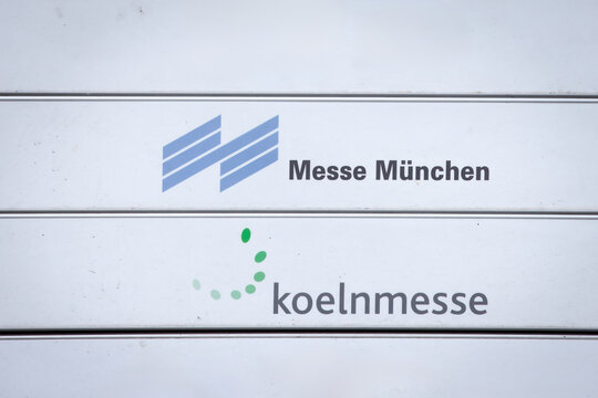 BELGRADE, SERBIA - AUGUST 21, 2021: Messe Munchen and Koelnmesse logos on a office panel in Belgrade, Serbia, on German trade fairs of Cologne and Munich, exhibition organizers and corporate branding.