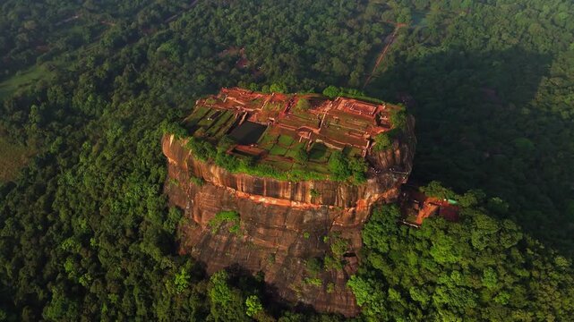 Cinematic aerial top-down of Sigiriya Lion Rock &ndash; Ancient fortress ruins and lush tropical jungle in the cultural triangle of Sri Lanka