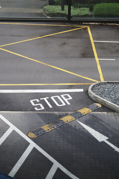 Marked stop area in a parking lot near a building