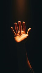Fototapeta premium Open hand reaching into dramatic spotlight