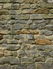 Obraz premium Historic stone wall texture with natural limestone blocks and aged masonry