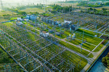 Modern high-voltage electrical substation and power transmission towers for electricity distribution.