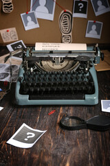 Retro typewriter and magnifier on wooden table against crime board