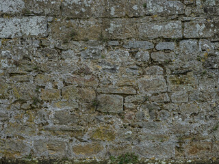 Old limestone masonry wall texture background with weathered stone surface