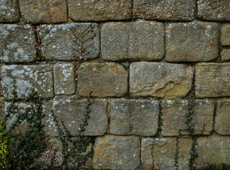 Ancient stone wall texture with rough limestone blocks and historic masonry