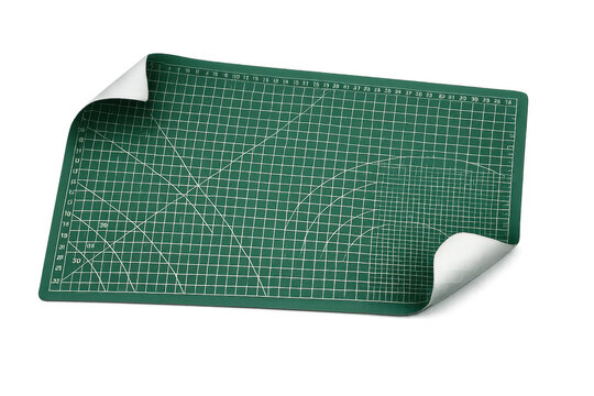 Green craft cutting mat with grid lines and curled corners