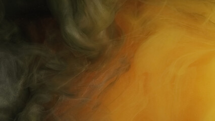 Fototapeta premium Paint blend. Color haze pigment. Defocused orange green yellow glitter dye vapor cloud smoke spreading on abstract art background.