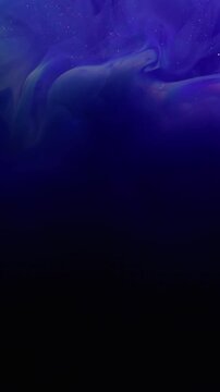 Vertical video. Shimmering dust. Defocused stream. Purple blue violet shiny paint powder swirl spill on black background. Abstract color glow water texture.