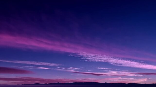 Vibrant Sunset Sky with Purple and Blue Clouds over Mountains