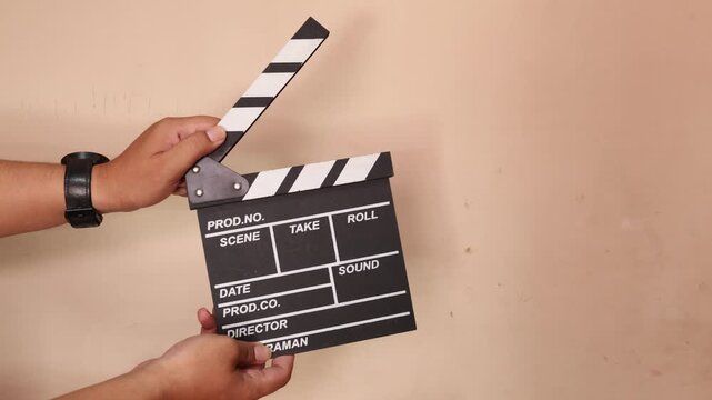 man with a traditional wooden clapperboard. Man holding a clapper. 4k video
