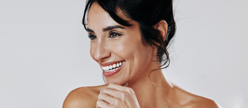 Thinking, skincare and woman in studio, funny and dermatology on white background. Wellness, shine and mature person with cosmetics, reflection and healthy skin for glow, laughing and wallpaper