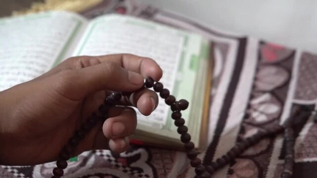 Muslim Hand Counting Tasbih Beads During Prayer