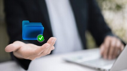 Fototapeta premium Person holding a blue folder with a checkmark symbol on it.