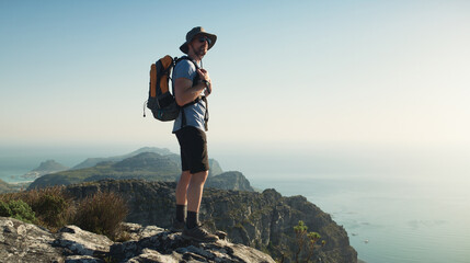 View, man and hiking with backpack on cliff for travel adventure, tourism or nature appreciation....