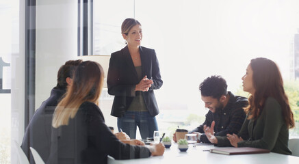 Presenter, planning and business woman with team for compliance, coaching or pitch idea in office. Presentation, speaking and happy group in meeting for policy briefing, training and strategy © peopleimages.com
