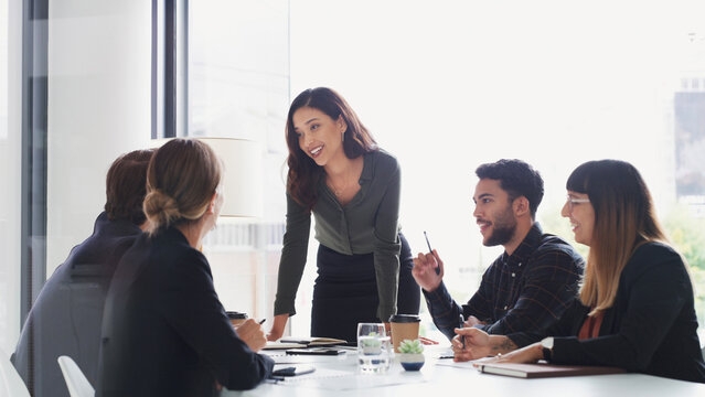 Business people, meeting and presentation with woman in office for training, discussion and workshop. Education, project management and upskill development with corporate staff team and communication