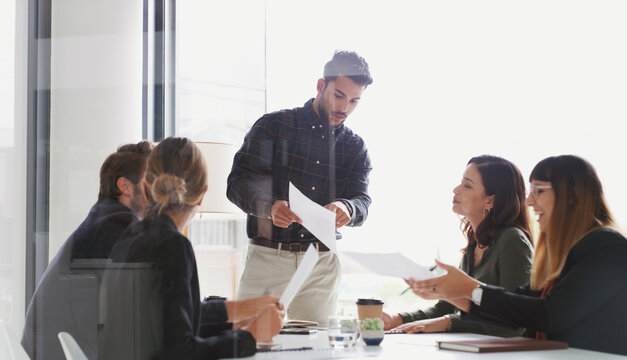Corporate, people and meeting with document in office for planning, expansion report and contract. Man, team or review paperwork for auction agreement, listing information and real estate negotiation