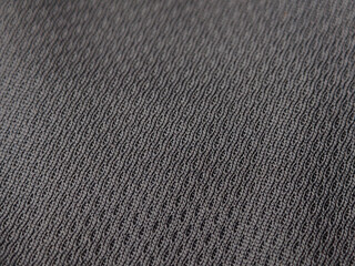 Close-up of a gray textured fabric commonly used for moisture-wicking athletic jerseys